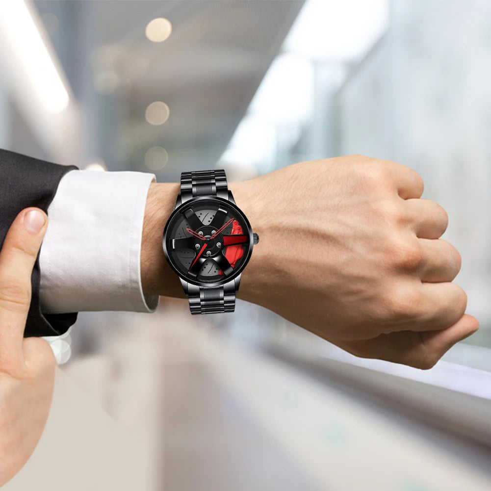 Person wearing a black and red watch on a blurred background